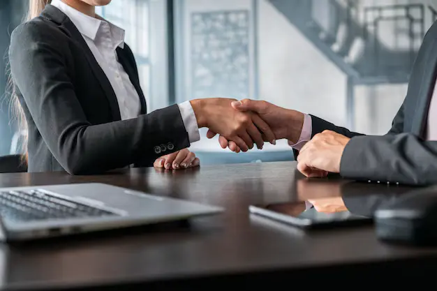 Business professionals shaking hands